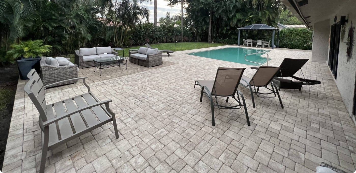 The same pool deck after Sheesh pressure washing — bright, clean pavers